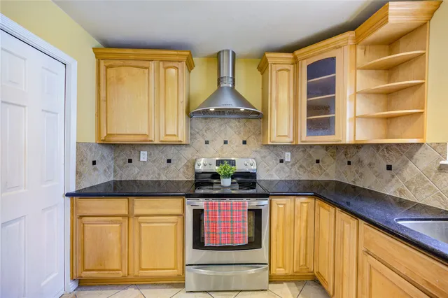 a kitchen with stainless steel appliances granite countertop a sink and cabinets