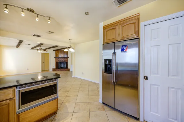a kitchen with stainless steel appliances granite countertop a refrigerator and a stove
