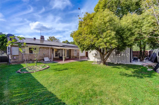 a view of a house with a yard porch and sitting area