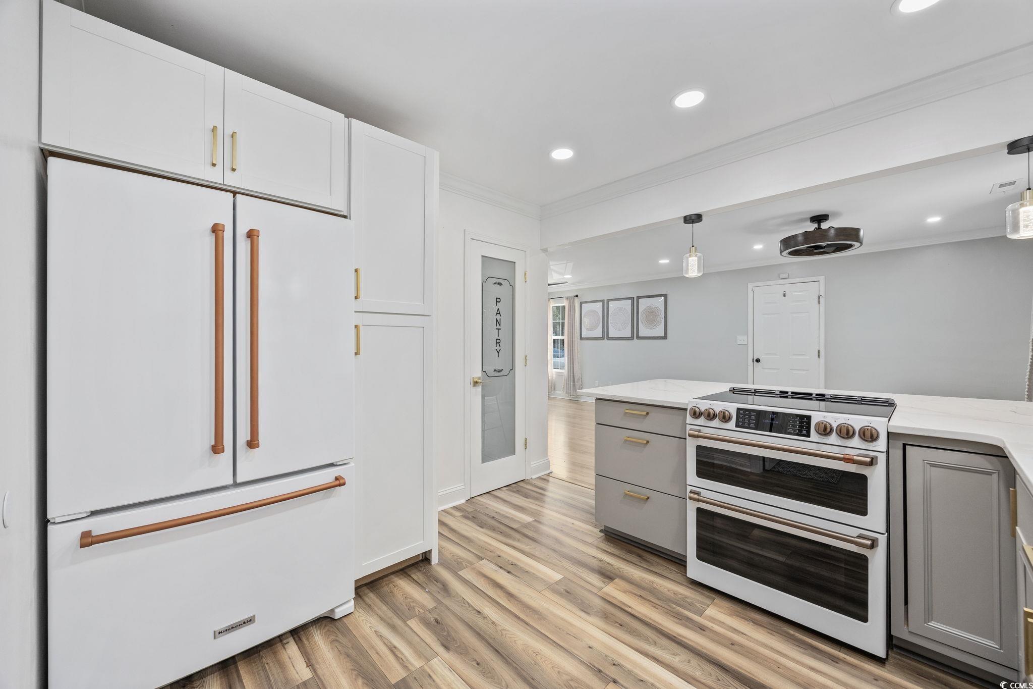 118 Sly Fox Trail Myrtle Beach, SC 29588 - Photo 17 of 40 Kitchen with premium appliances, gray cabinets, recessed lighting, hanging light fixtures, and light wood-style floors