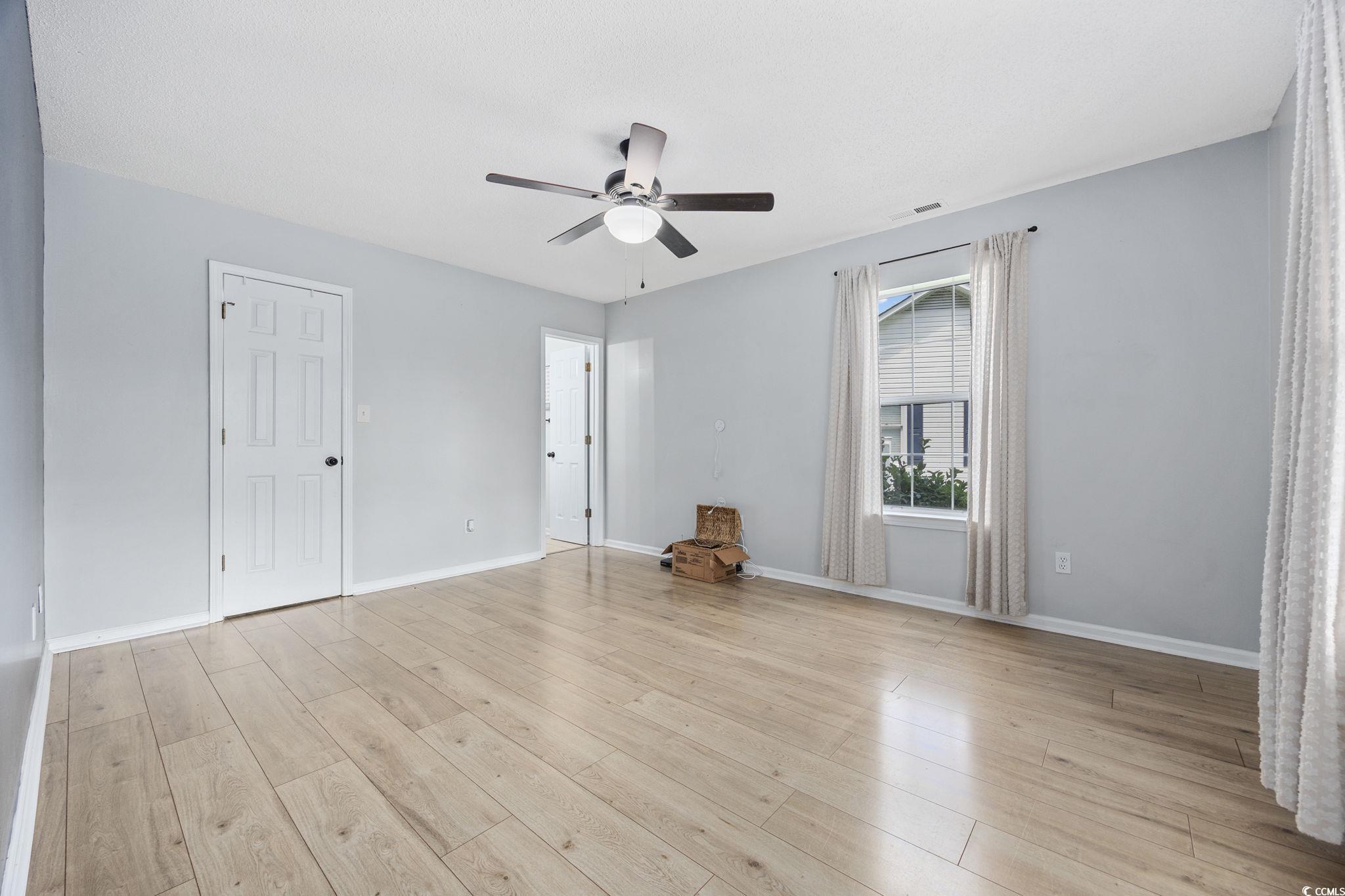 118 Sly Fox Trail Myrtle Beach, SC 29588 - Photo 18 of 40 Unfurnished bedroom featuring ceiling fan and light wood finished floors