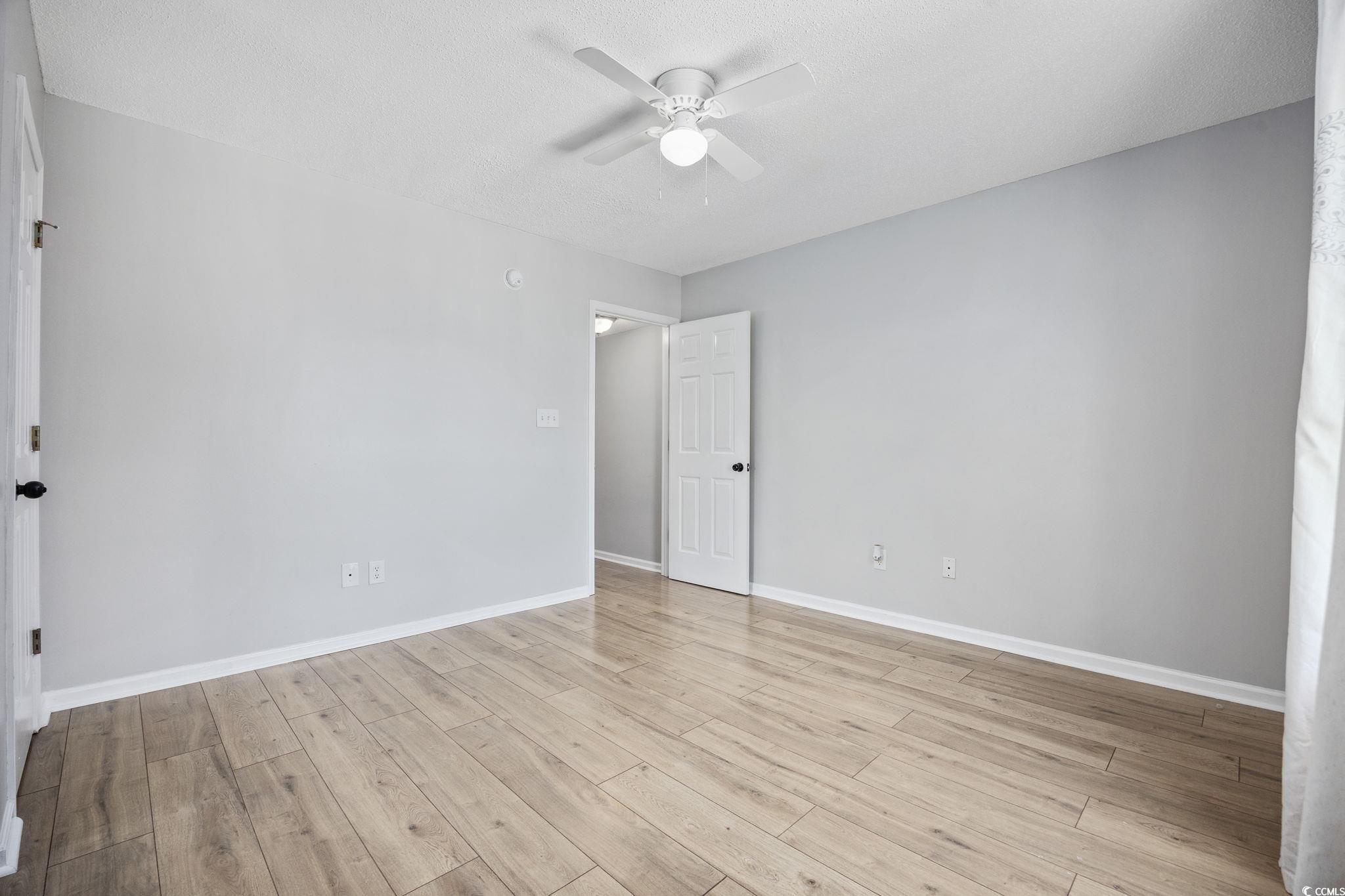 118 Sly Fox Trail Myrtle Beach, SC 29588 - Photo 23 of 40 Unfurnished bedroom featuring ceiling fan, light wood-style floors, and a textured ceiling