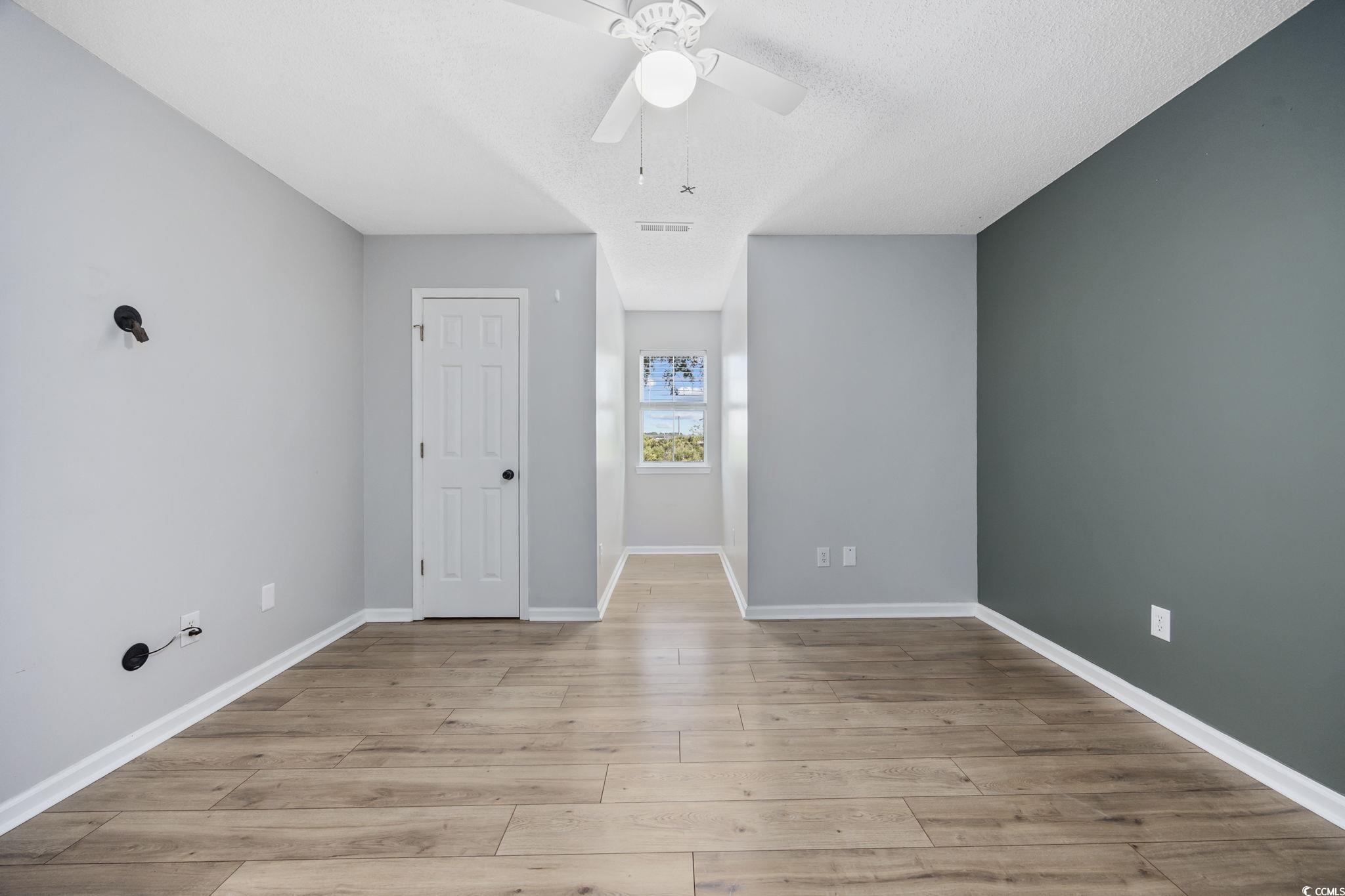 118 Sly Fox Trail Myrtle Beach, SC 29588 - Photo 25 of 40 Spare room with light wood finished floors, a ceiling fan, and a textured ceiling