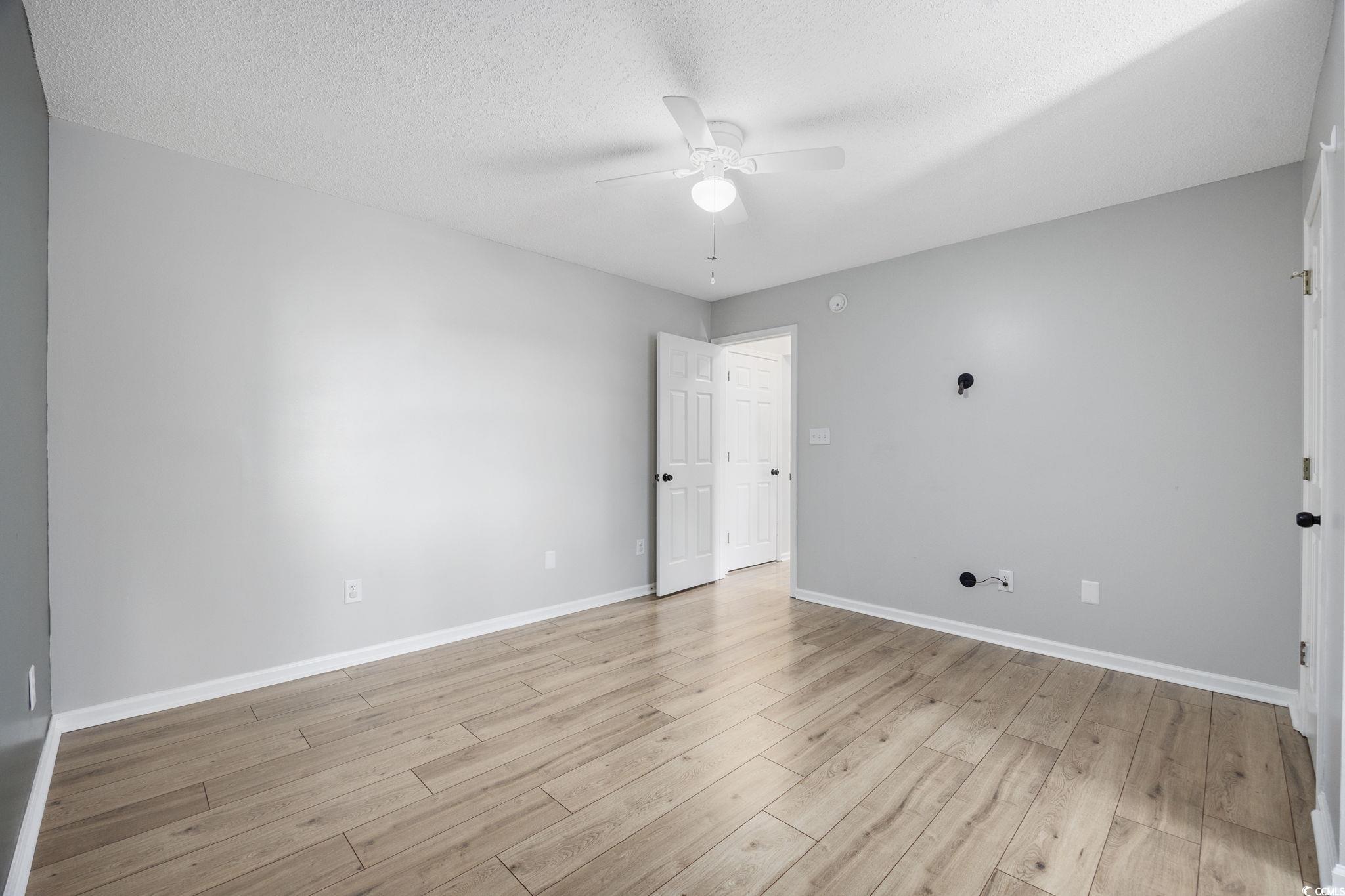 118 Sly Fox Trail Myrtle Beach, SC 29588 - Photo 26 of 40 Spare room with light wood-style floors, a textured ceiling, and a ceiling fan