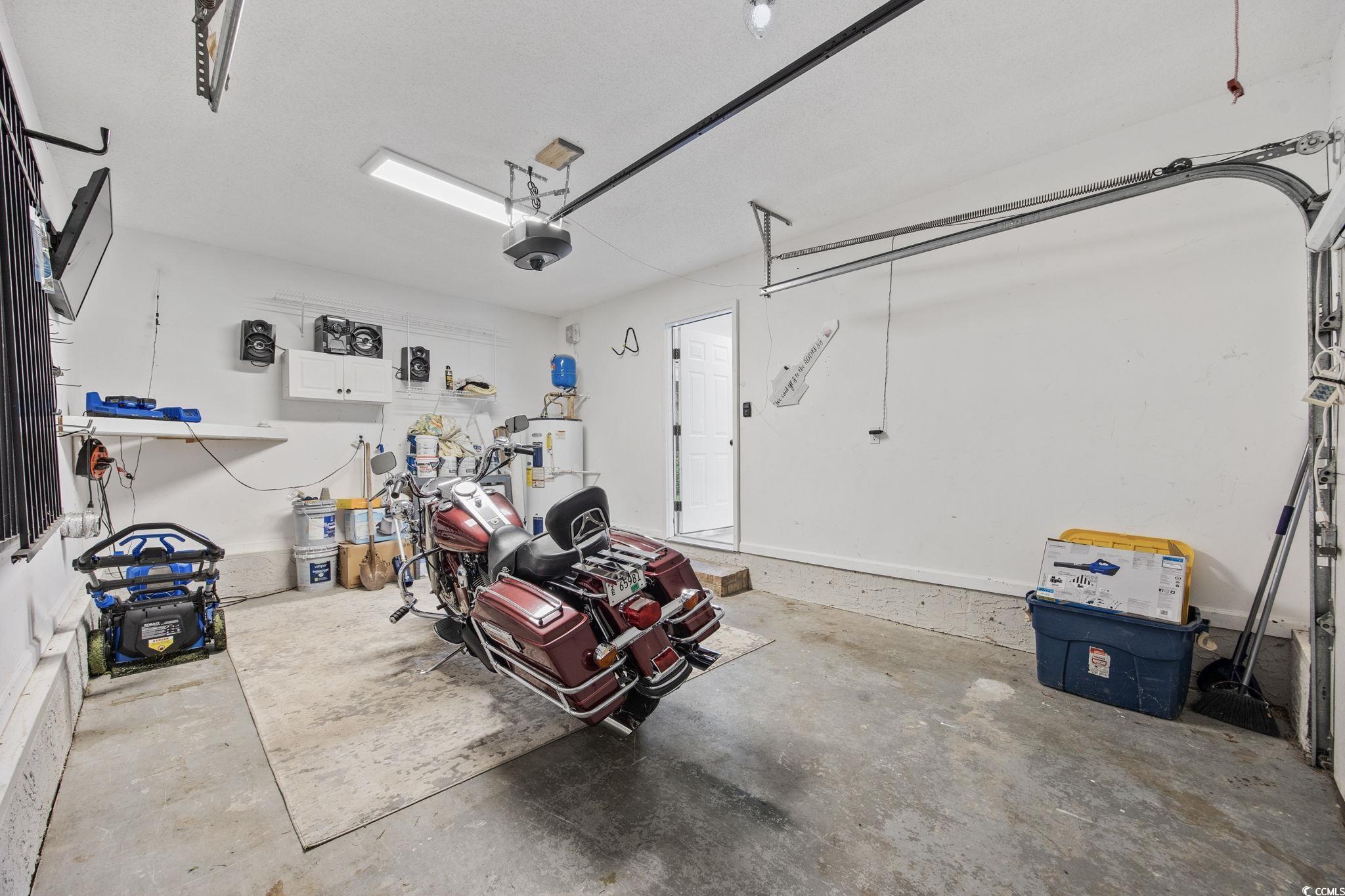 118 Sly Fox Trail Myrtle Beach, SC 29588 - Photo 29 of 40 Garage with electric water heater and a garage door opener