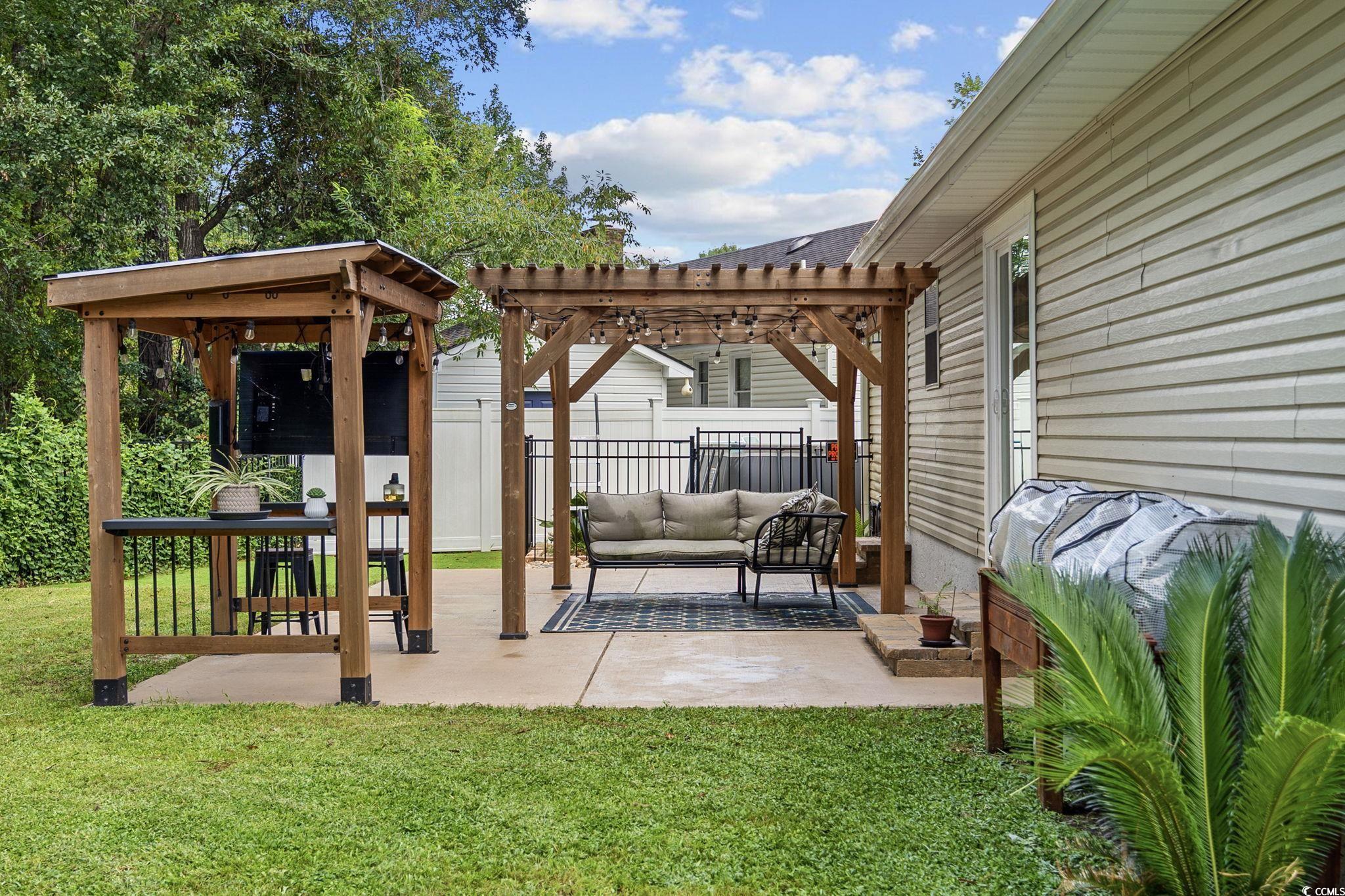 118 Sly Fox Trail Myrtle Beach, SC 29588 - Photo 34 of 40 View of patio with a pergola, an outdoor hangout area, and a grill