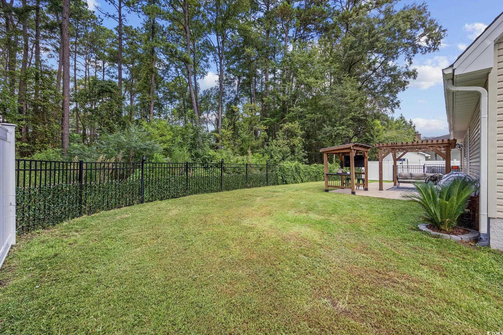 118 Sly Fox Trail Myrtle Beach, SC 29588 - Photo 35 of 40 Fenced backyard with a pergola and a patio area