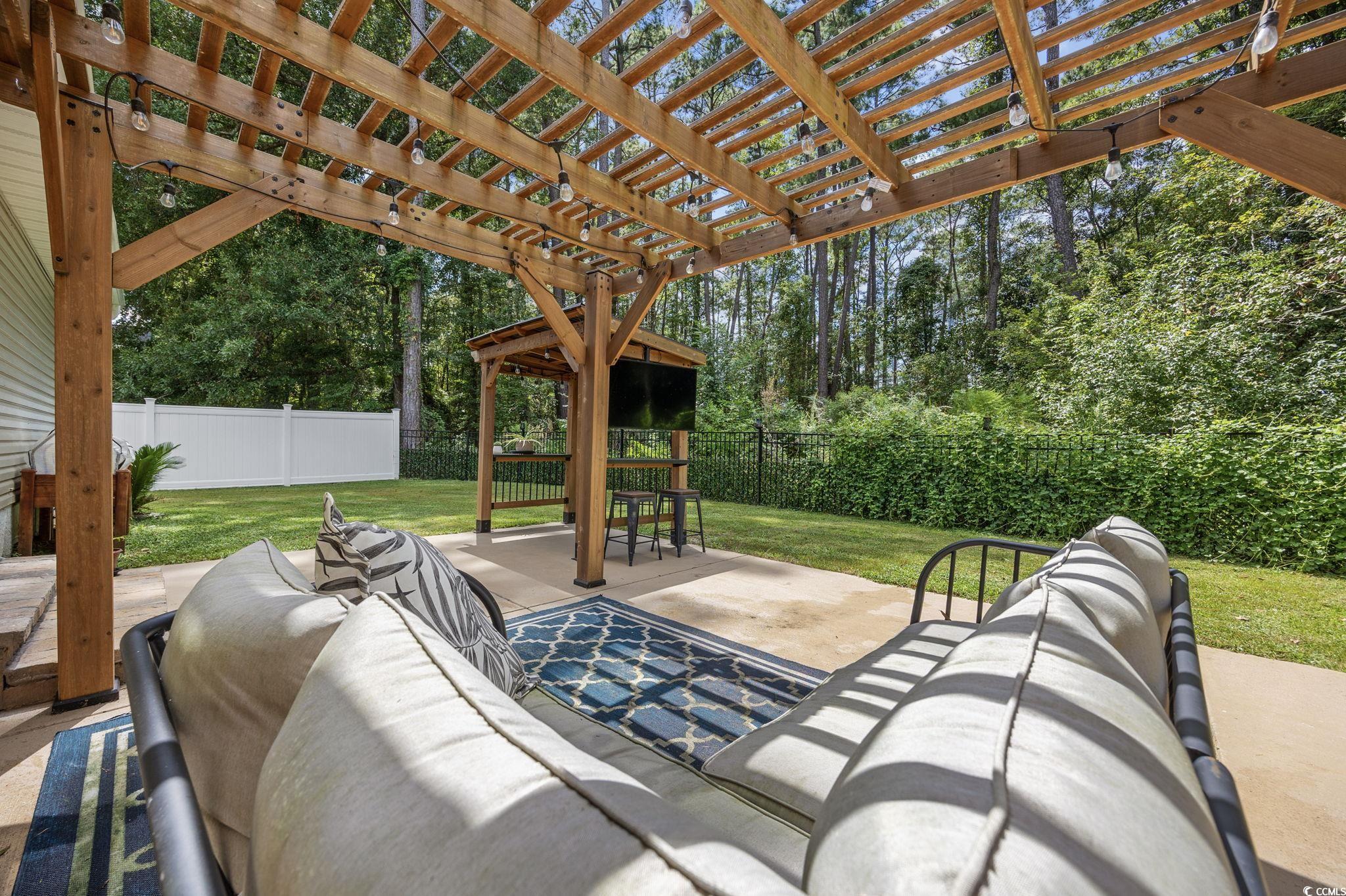 118 Sly Fox Trail Myrtle Beach, SC 29588 - Photo 39 of 40 Fenced backyard with outdoor lounge area, a pergola, and a patio
