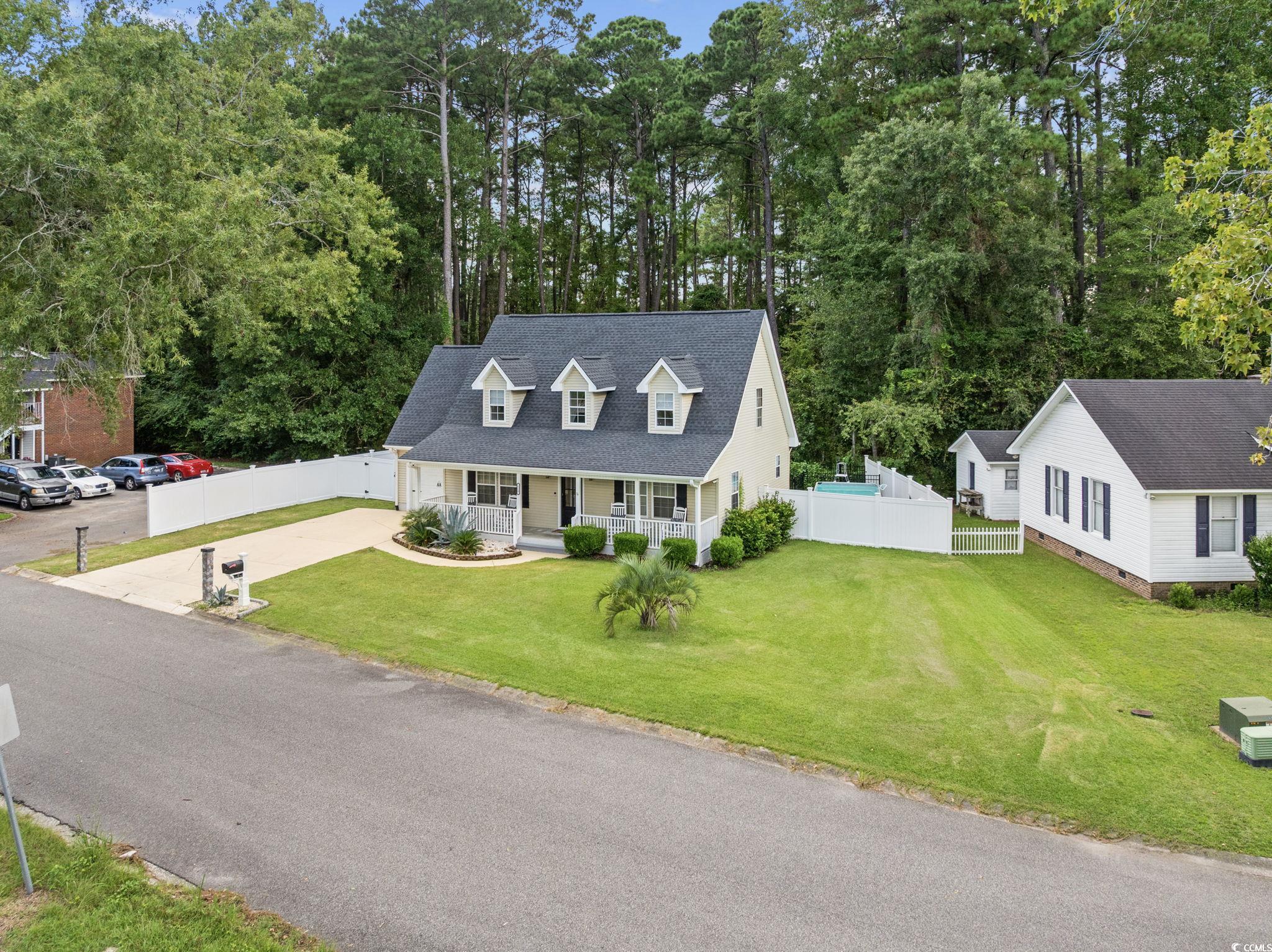 118 Sly Fox Trail Myrtle Beach, SC 29588 - Photo 4 of 40 Cape cod-style house featuring covered porch and driveway