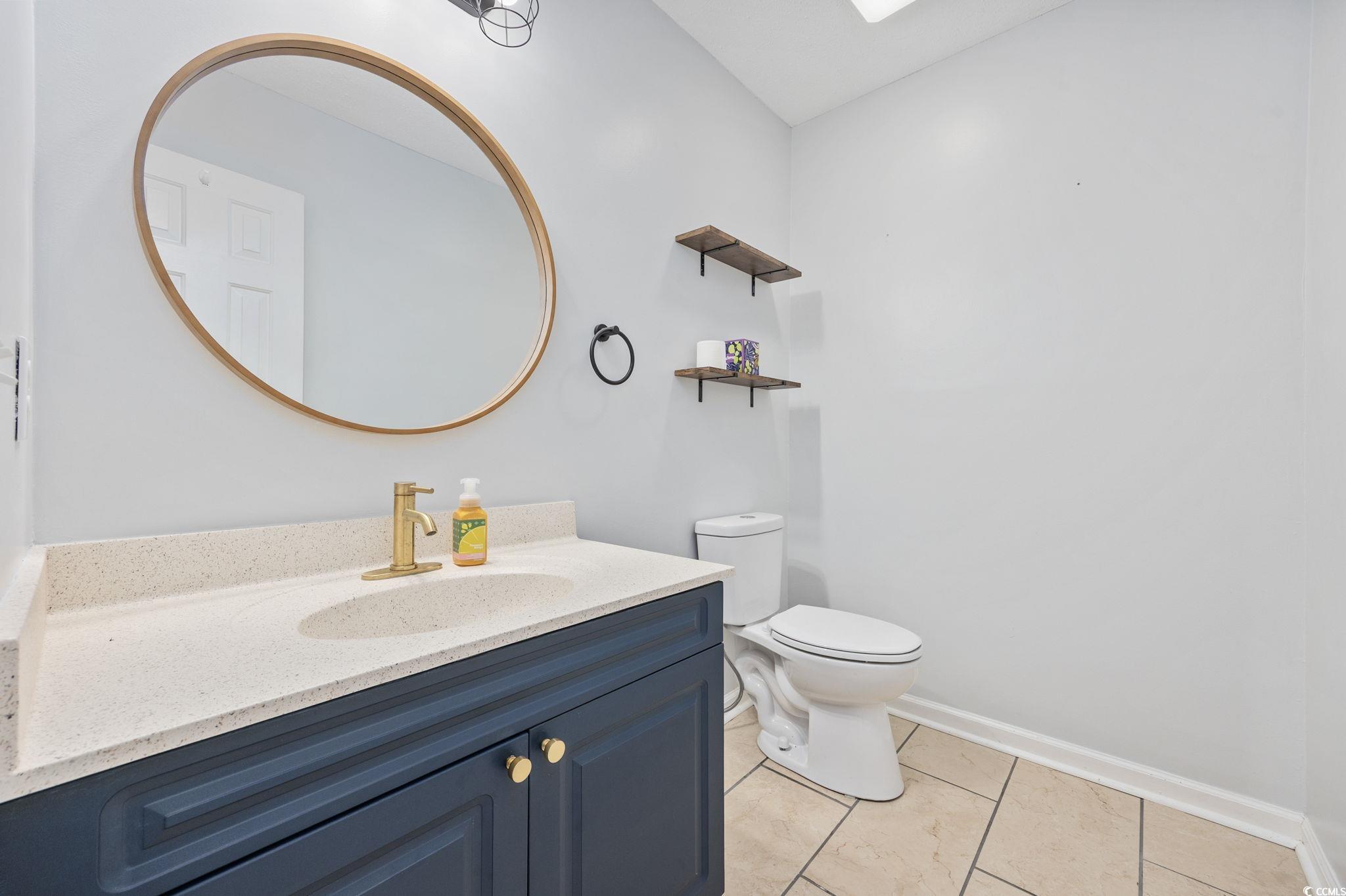 118 Sly Fox Trail Myrtle Beach, SC 29588 - Photo 6 of 40 Bathroom with vanity, light tile patterned floors, and a skylight