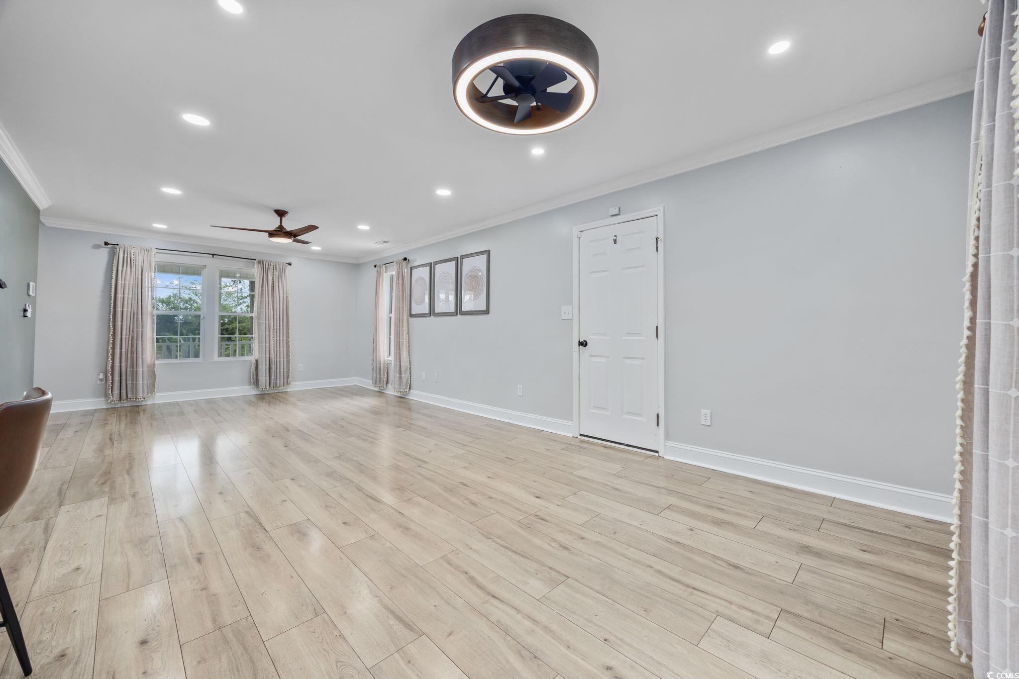 118 Sly Fox Trail Myrtle Beach, SC 29588 - Photo 8 of 40 Unfurnished living room featuring recessed lighting, ornamental molding, light wood-style floors, and ceiling fan