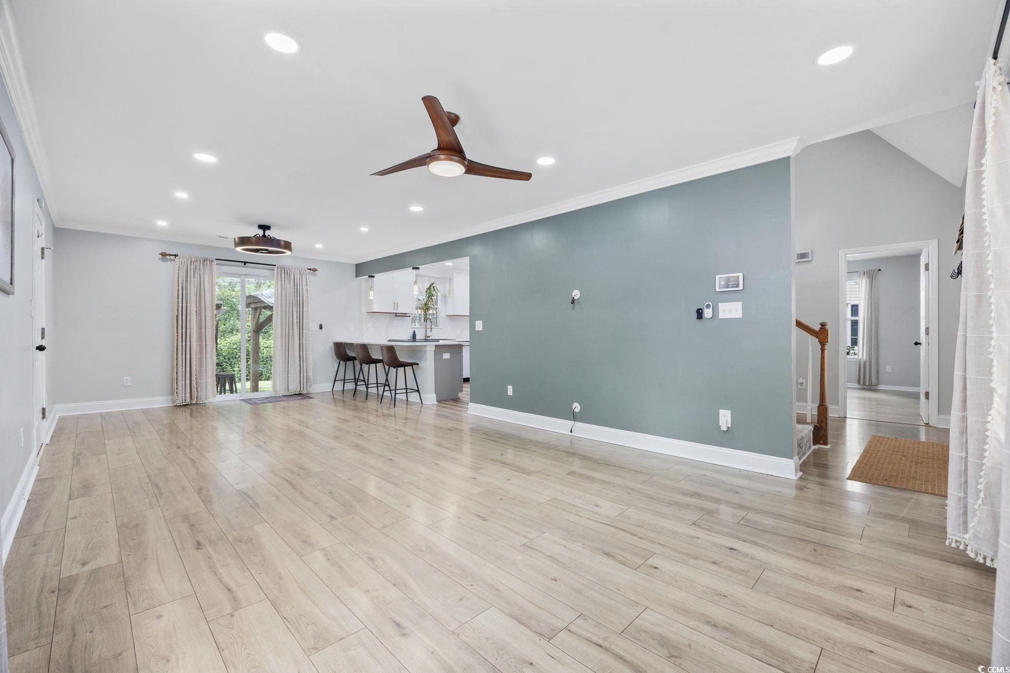 118 Sly Fox Trail Myrtle Beach, SC 29588 - Photo 9 of 40 Unfurnished living room featuring crown molding, recessed lighting, light wood-type flooring, and a ceiling fan