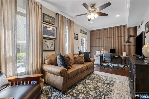 a living room with furniture a flat screen tv and a window