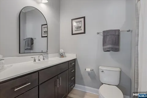 a bathroom with a toilet a sink and mirror