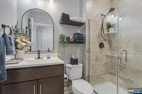 a bathroom with a sink a toilet and shower