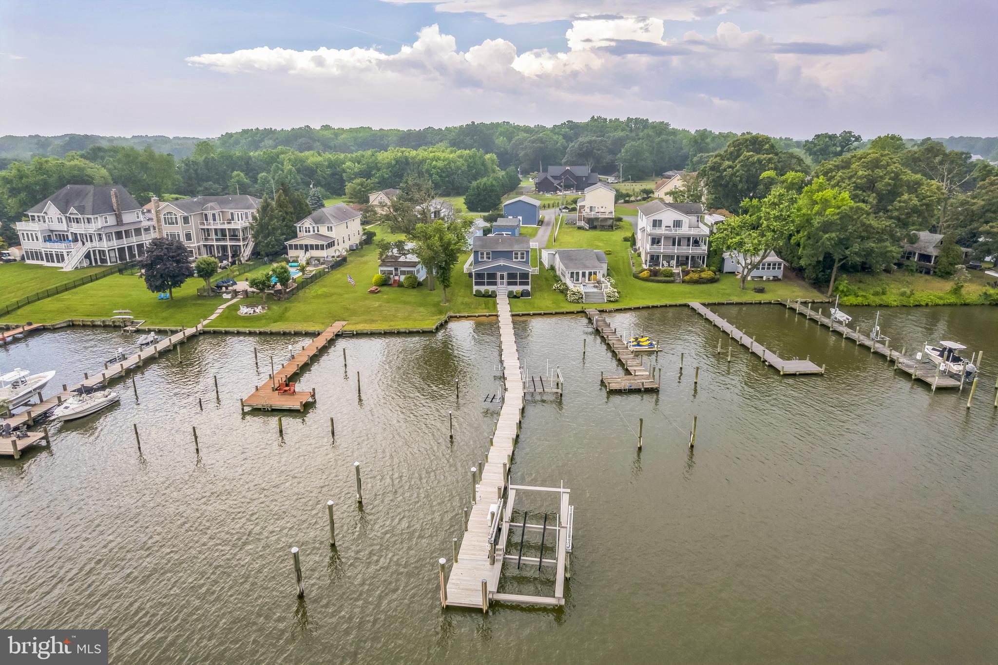 a view of a swimming pool with a yard and lake view