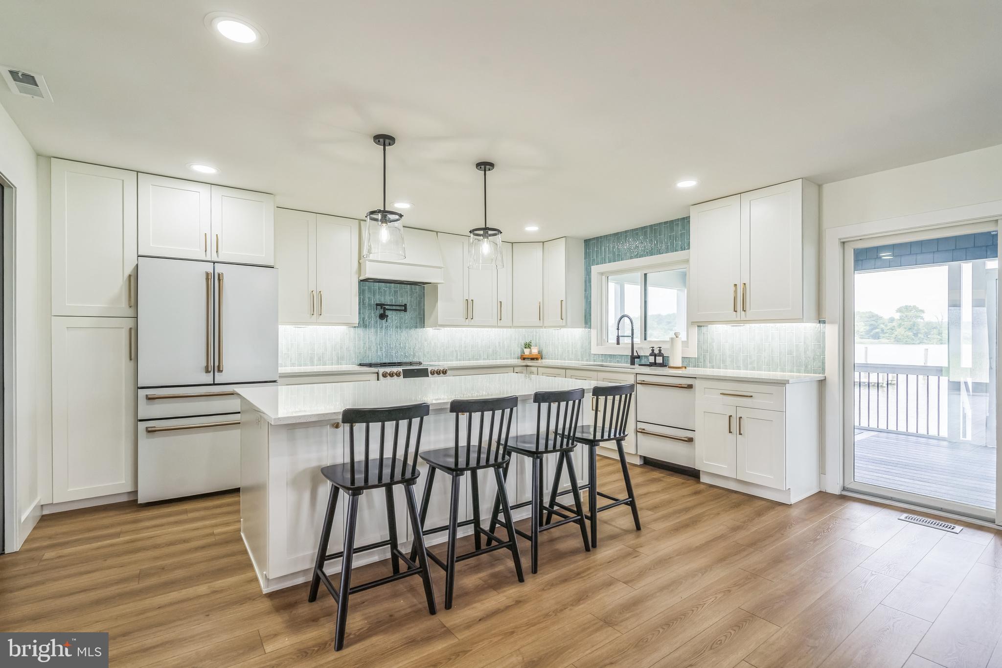 4012 Chestnut Road Baltimore, MD 21220 - Photo 27 of 58 a kitchen with white cabinets and stainless steel appliances