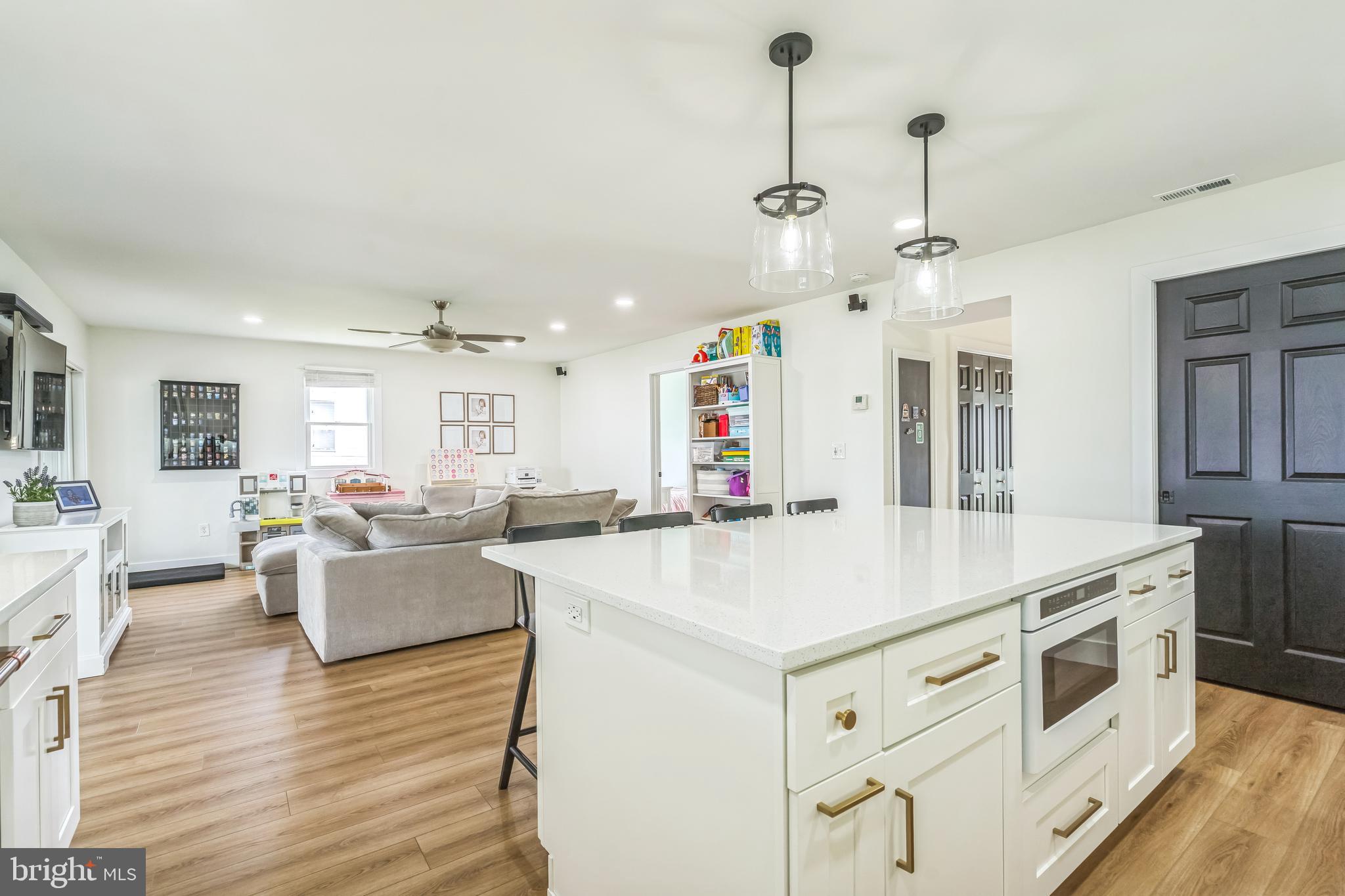 4012 Chestnut Road Baltimore, MD 21220 - Photo 33 of 58 a open kitchen with cabinets a sink dishwasher a dining table and chairs with wooden floor