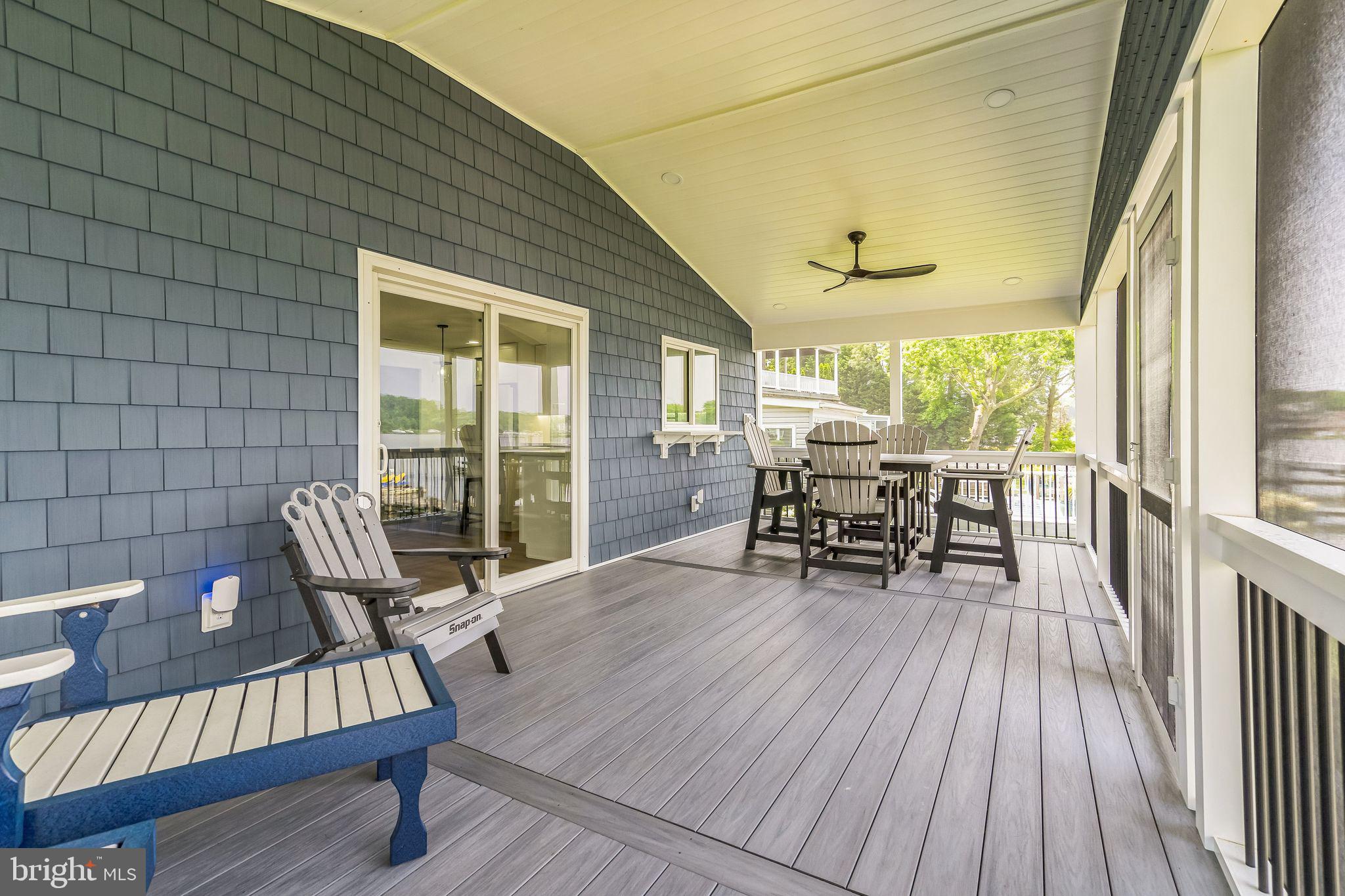 4012 Chestnut Road Baltimore, MD 21220 - Photo 39 of 58 a view of a deck with table and chairs and wooden floor