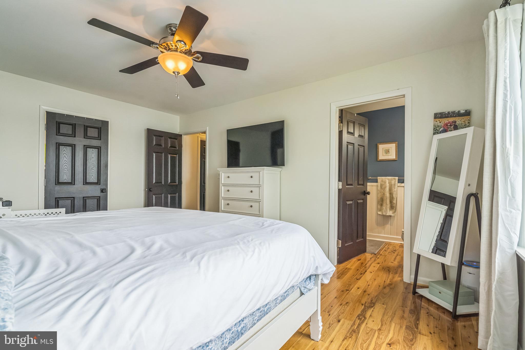 4012 Chestnut Road Baltimore, MD 21220 - Photo 45 of 58 a bedroom with a bed and a flat tv screen on dresser