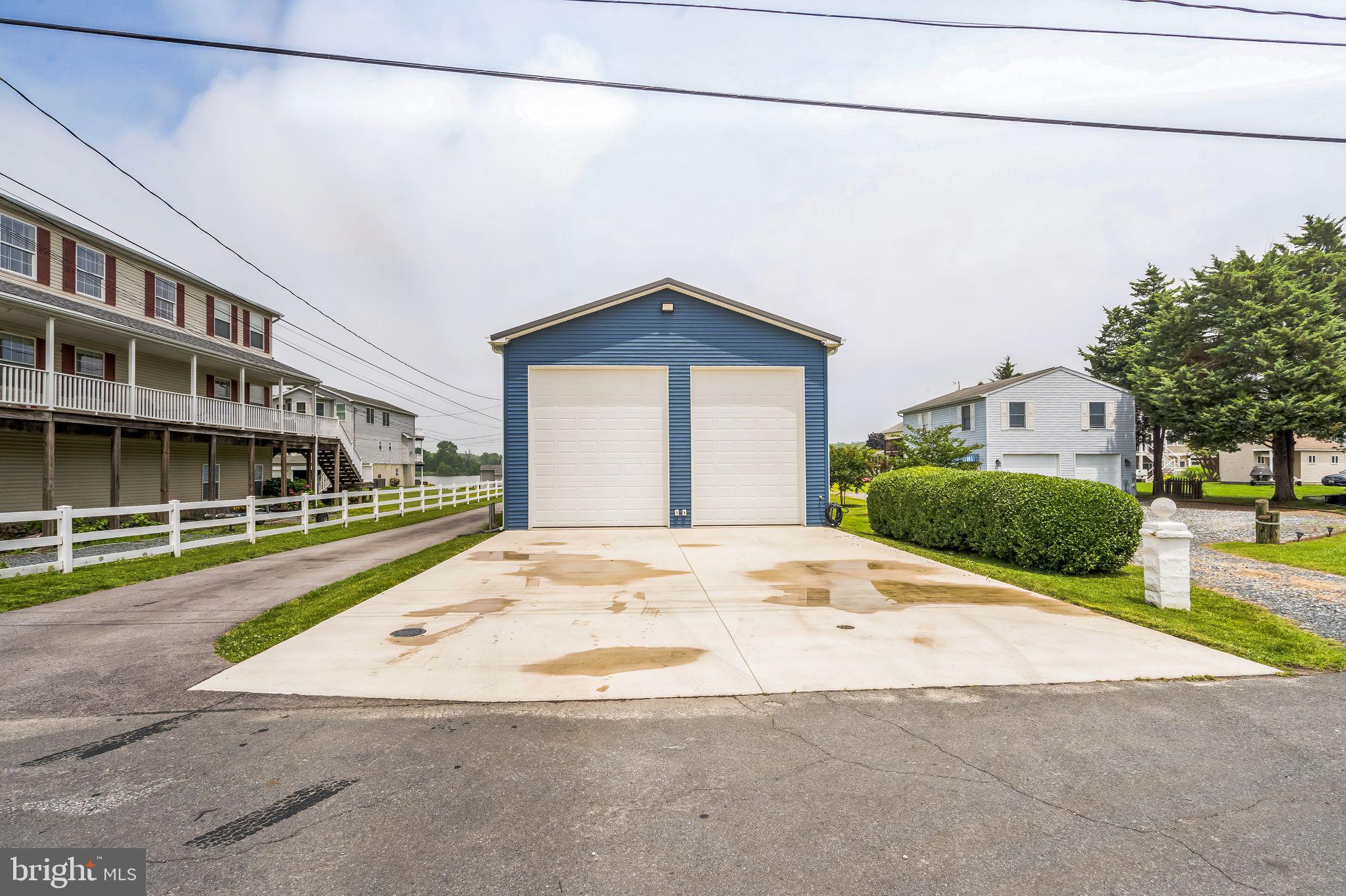4012 Chestnut Road Baltimore, MD 21220 - Photo 9 of 58 a front view of a house with a yard and garage