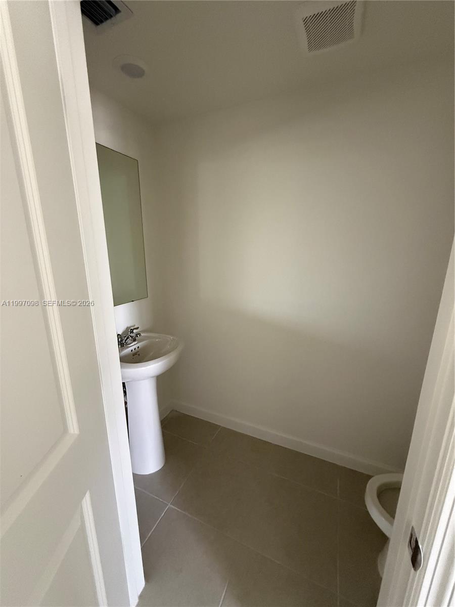 17907 Southwest 356th Street, Unit 17907 Homestead, FL 33034 - Photo 4 of 14 a bathroom with a sink and toilet