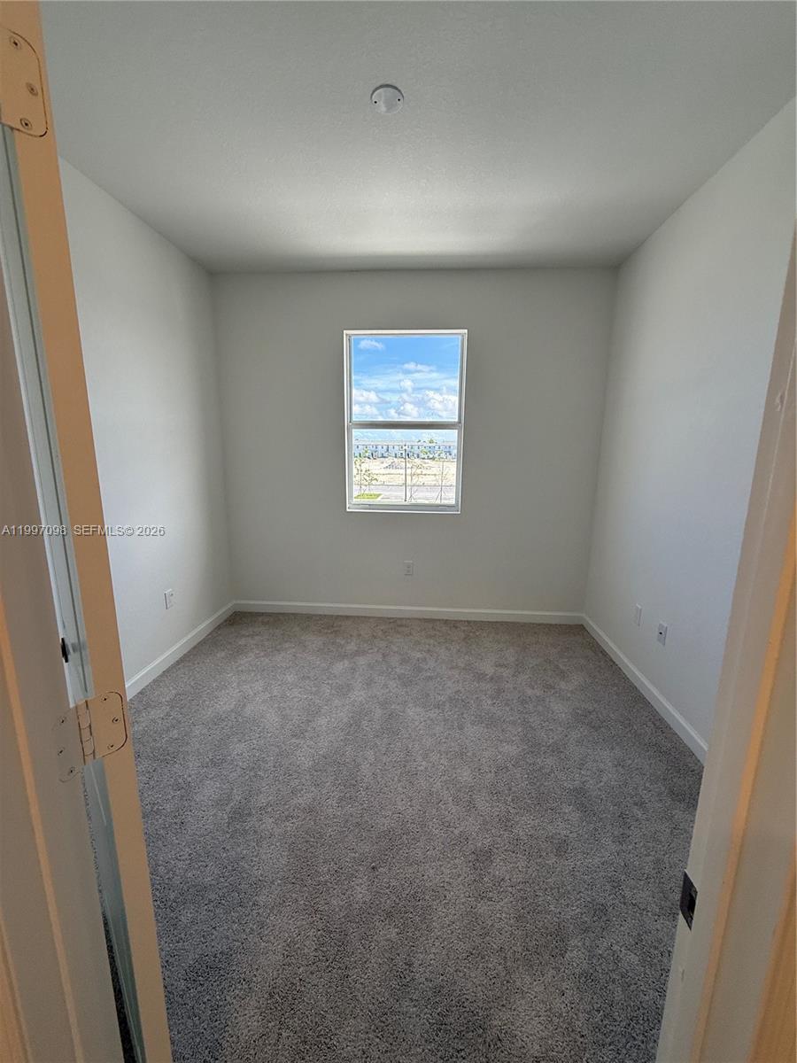 17907 Southwest 356th Street, Unit 17907 Homestead, FL 33034 - Photo 7 of 14 an empty room with a window