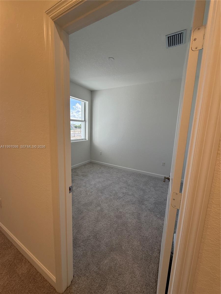 17907 Southwest 356th Street, Unit 17907 Homestead, FL 33034 - Photo 8 of 14 a view of an empty room