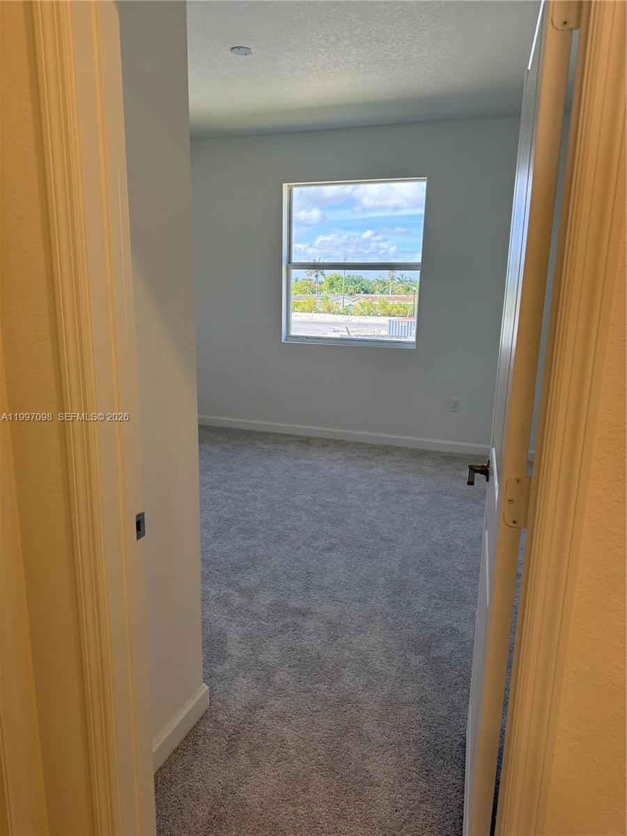 17907 Southwest 356th Street, Unit 17907 Homestead, FL 33034 - Photo 9 of 14 a view of an empty room