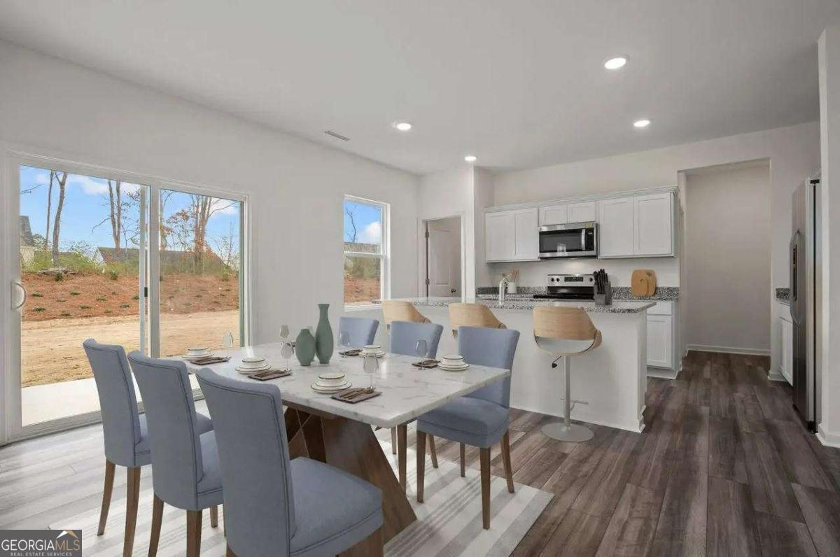 494 Otway Loop Winder, GA 30620 - Photo 7 of 17 a view of a dining room with furniture large windows and wooden floor