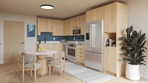 a kitchen with stainless steel appliances a refrigerator sink and cabinets