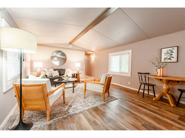 a living room with furniture a wooden floor and a window