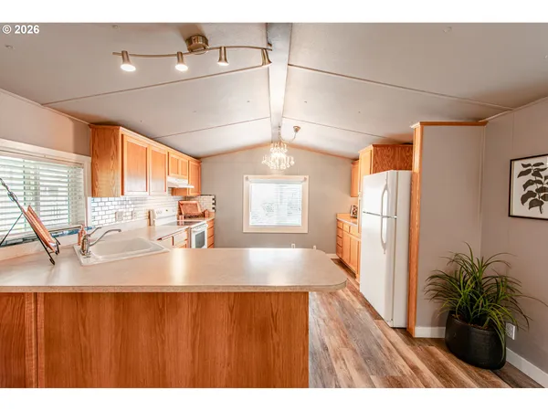 a view of kitchen and dining room with wooden floor