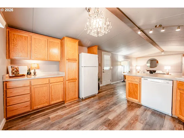 a kitchen with a refrigerator and white cabinets