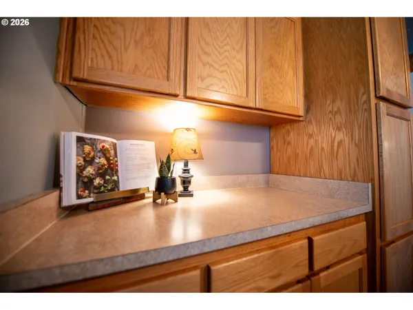 a kitchen with a sink cabinets and a window