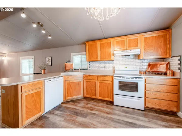 a kitchen with granite countertop a stove sink and cabinets