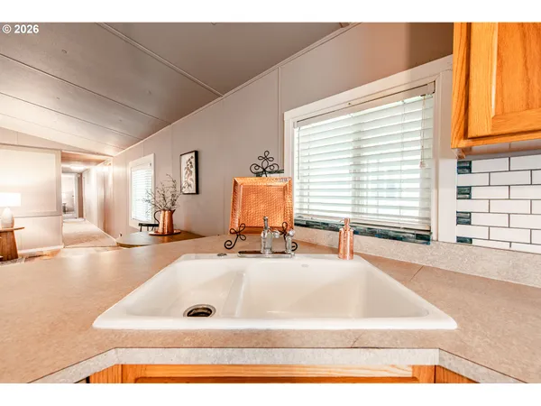a bathroom with a tub a sink and a window
