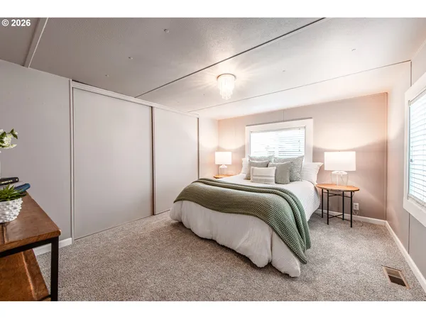a bedroom with a bed and a window
