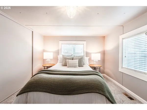 a bedroom with a bed and window