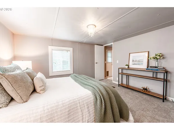 a bedroom with a bed and paintings on the wall