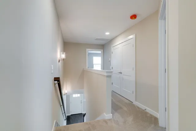 a view of a hallway to rooms