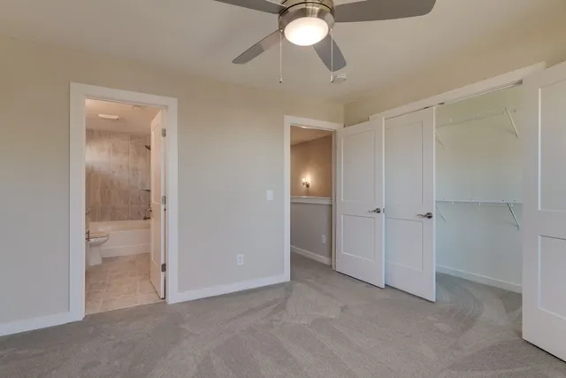 a view of an empty room and a bathroom
