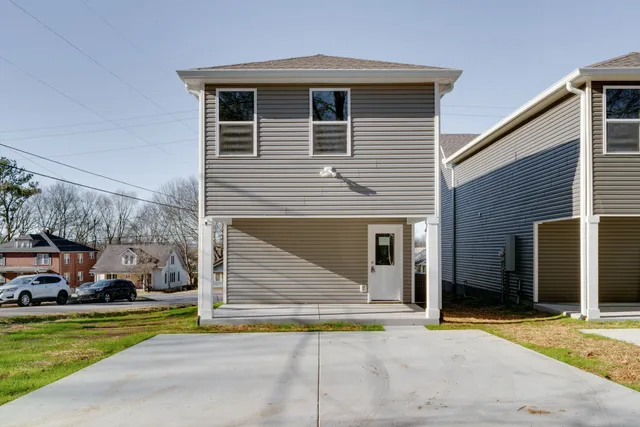 a front view of a house with a yard and a garage