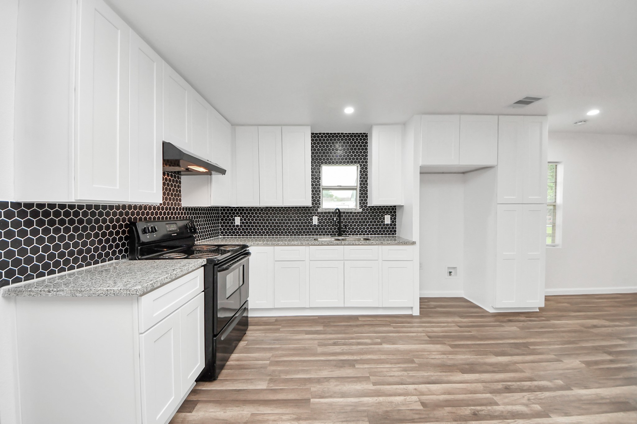 207 East Defee Avenue Baytown, TX 77520 - Photo 13 of 36 a kitchen with a sink stove and refrigerator
