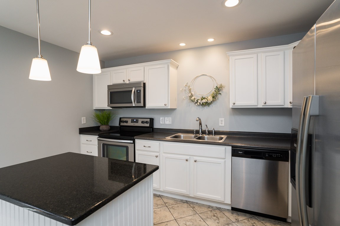 711 Kent Road Nashville, TN 37214 - Photo 11 of 31 a kitchen with granite countertop a stove a sink and a microwave