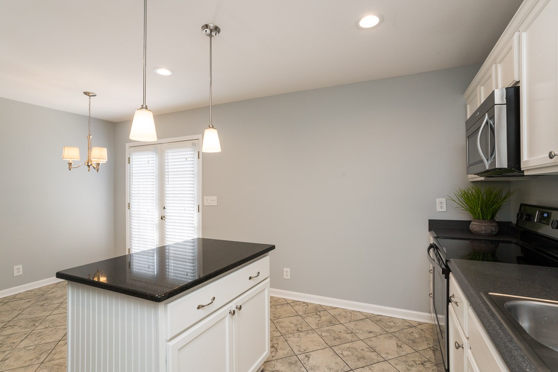 711 Kent Road Nashville, TN 37214 - Photo 13 of 31 a kitchen with granite countertop a sink a counter space appliances and cabinets
