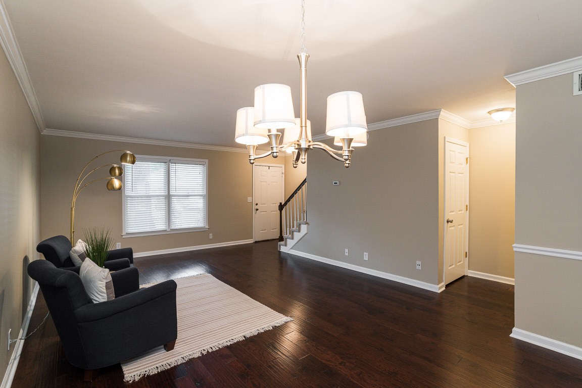 711 Kent Road Nashville, TN 37214 - Photo 7 of 31 a living room with couches chandelier and a dining table with wooden floor