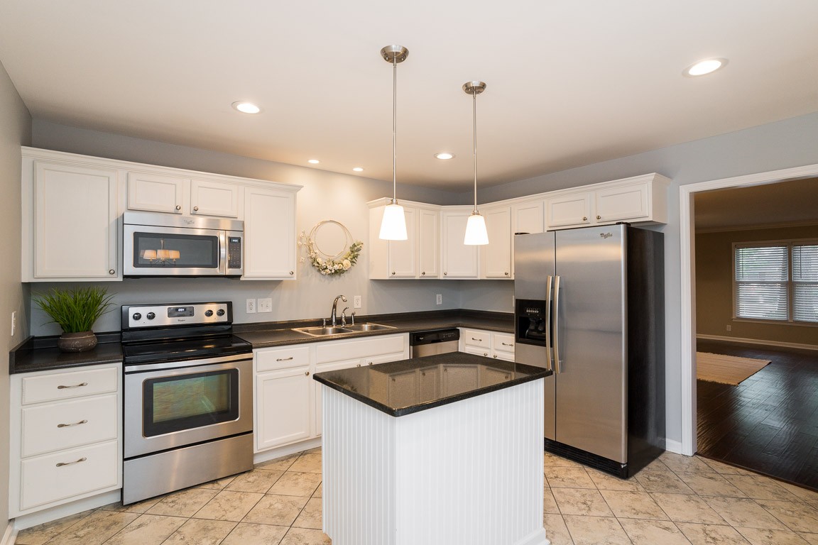 711 Kent Road Nashville, TN 37214 - Photo 10 of 31 a kitchen with stainless steel appliances granite countertop a sink a stove a refrigerator and a oven with wooden floor
