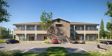 a view of house with outdoor space and parking