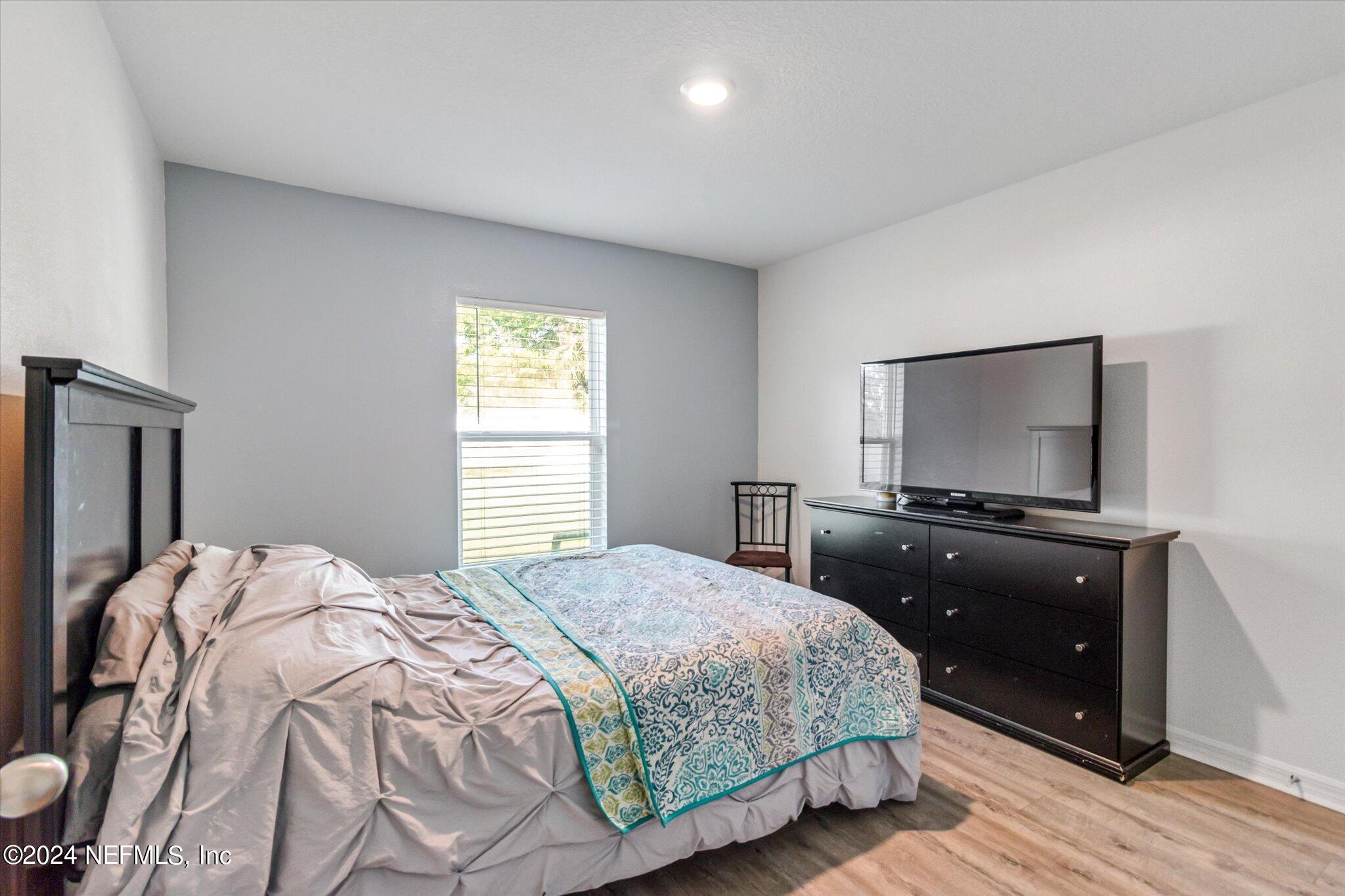 3 Pinwheel Lane Palm Coast, FL 32164 - Photo 13 of 20 a bedroom with a bed and a flat screen tv